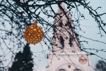 Christmas ornament on a tree near rural church