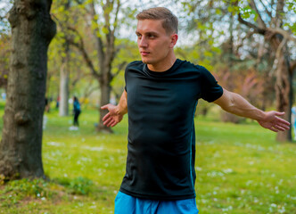 Man stretching hamstring arms muscles during outdoor crossfit workout