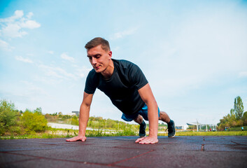 Fit man doing clapping push-ups during training exercise workout