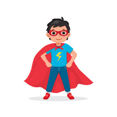 Cute little boy plays wearing superhero costumes standing with hands on his hips pose