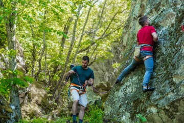 People are rock climbing in nature