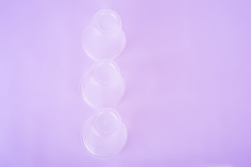 crush transparent plastic drinks cups on the very peri background. zero waste concept. no plastic. top view. flat lay.