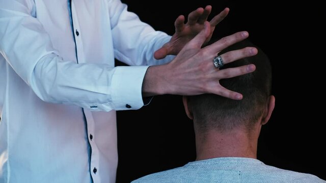 Biofield treatment and telepathy. A man diagnoses a patient using the biofield of his hands