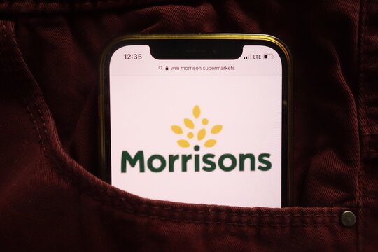 KONSKIE, POLAND - January 15, 2022: WM Morrison Supermarkets logo on mobile phone hidden in jeans pocket