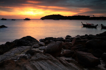 Fototapeta na wymiar sunset seascape with stone arch at Lipe