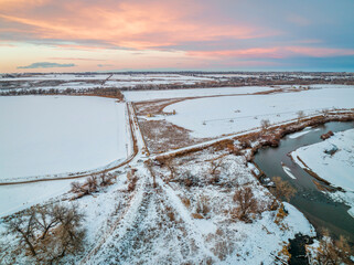 dusk over South Platte River and farmland on Colorado plains near Milliken, aerial view with winter scenery
