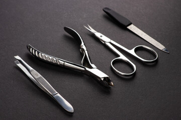 Tools of a manicure set on a dark background