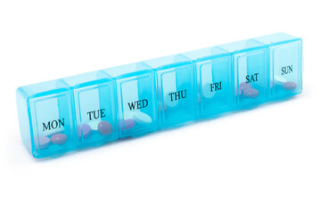 Pill organizer with variety of pills and supplement. a plastic weekly.