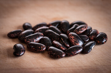 Crop of Celebration runner beans, shelled and piled on wooden kitchen board.