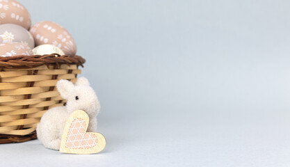 Easter bunny with basket full of easter eggs. Spring holiday concept, copy space photo