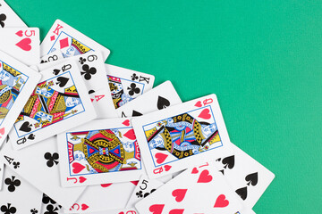 Playing cards on green background.