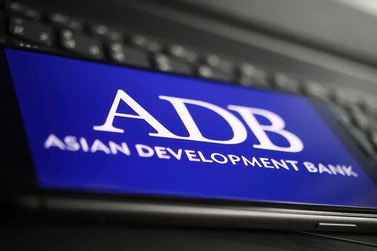 Viersen, Germany - January 9. 2022: Closeup of mobile phone with logo lettering of adb asisan development bank on computer keyboard