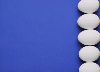 white eggs on blue background