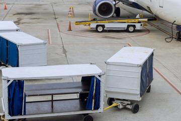 Airport runway with cargo transport on wait for airplane