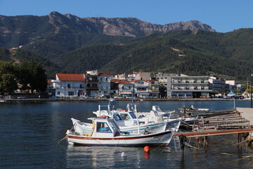 Fototapeta na wymiar Boats in the old harbor of Limenas city