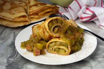 Thin German Pancakes (like French crepes) with sweet caramelized rhubarb filling, served with loads of cinnamon and sugar. The pancake is the classic from the kitchen of our childhood.