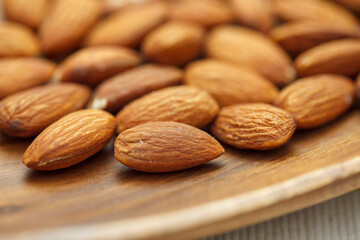 木の皿に乗った沢山のアーモンド