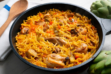 Noodles with noodles, artichokes and other vegetables. Traditional north spain dish.