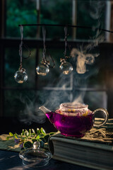 Violet tea still life with window and witchy magic atmosphere