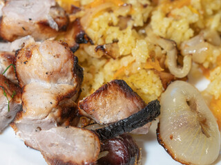 Pieces of fried pork, barbecue and rice. close-up