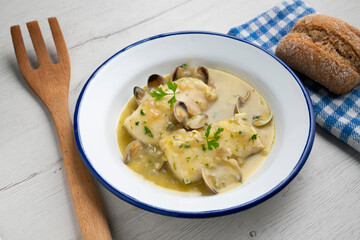 Hake in green sauce with parsley and clams. Traditional Spanish recipe.