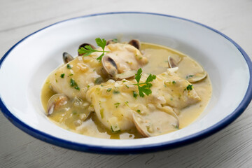 Hake in green sauce with parsley and clams. Traditional Spanish recipe.