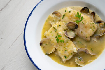 Hake in green sauce with parsley and clams. Traditional Spanish recipe.