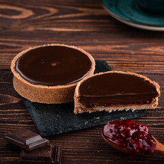 round tartlet in butter cream, baked tartlet dessert, chocolate tartlet with berry