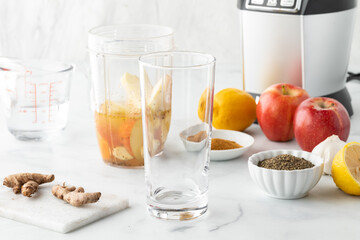 Blender cup filled with ingredients to make a healthy detox smoothie. 