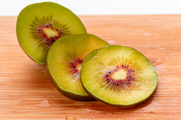 Red kiwi fruit berry slices macro natural light on breakfast wood healthy diet