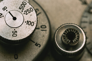 Shutter speed dial and shutter button of an old film camera close-up