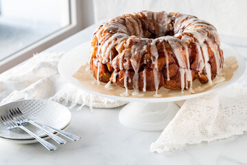 An apple cinnamon pull apart coffee cake drizzled with icing, ready for serving.