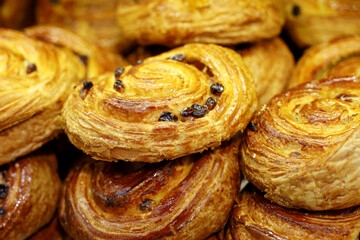 Puff pastry with raisins closeup. Freshly baked rolls for breakfast