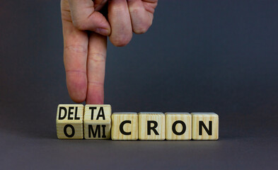 Covid-19 omicron or deltacron symbol. Doctor turns cubes and changes the word omicron to deltacron....