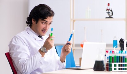 The young handsome chemist working in the lab