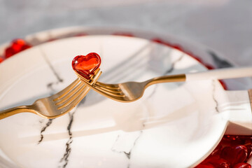 Banner. Heart on a fork close-up. Festive table setting. The concept of a holiday for cafes and restaurants. valentine's day. A copy of the space for the text.