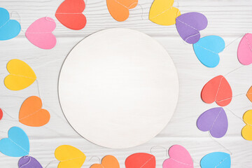 Mockup round sign decorated paper colorful hearts. Valentines day mock up on white woode...