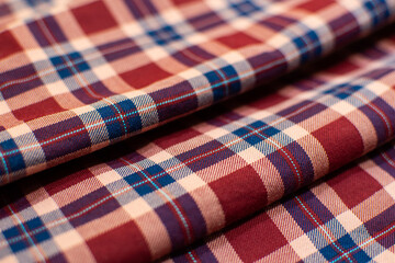 background of red cotton fabric with a checkered pattern