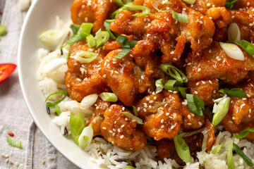 Asian crispy sweet sesame chicken with basmati, wild rice and spring onion.
