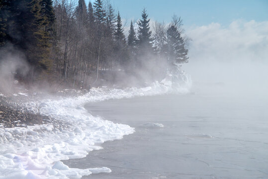 fog and ice on shoreline of lake