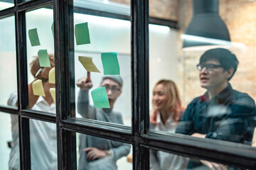 Closeup - Business asian people meeting at office and use post it notes to plan and share idea. Brainstorming concept