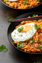 Kimchi fried rice with fried egg and bacon. Korean food