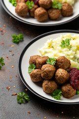 Homemade Swedish Meatballs with cranberry relish Sauce, potato mash and peas