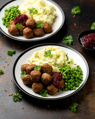 Homemade Swedish Meatballs with cranberry relish Sauce, potato mash and peas