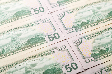 Close-up of fifty dollar bills spread out.