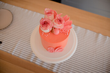 pink cake with roses and petals