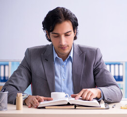 The young handsome teacher in front of whiteboard