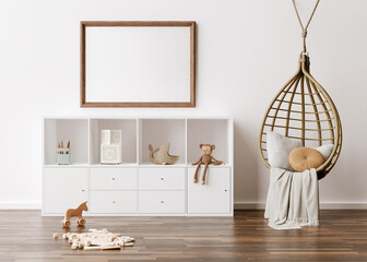 Empty picture frame on white wall in modern child room. Mock up interior in scandinavian, boho style. Free, copy space for your picture. Console, rattan armchair, toys. Cozy room for kids 3D rendering