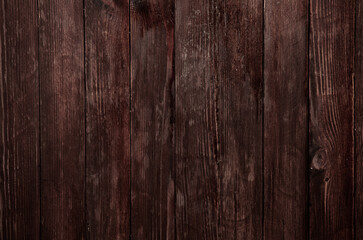 Vintage brown wood background texture with knots and nail holes. Old painted wood wall. Wooden dark horizontal boards