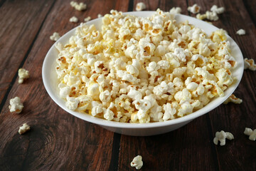 tasty popcorn in a white bowl top view